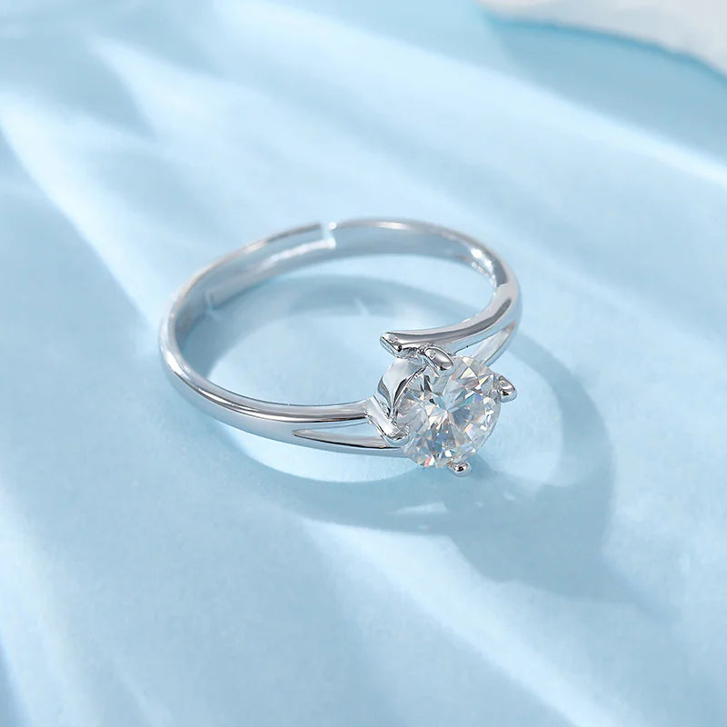 A sterling silver ring with a radiant diamond